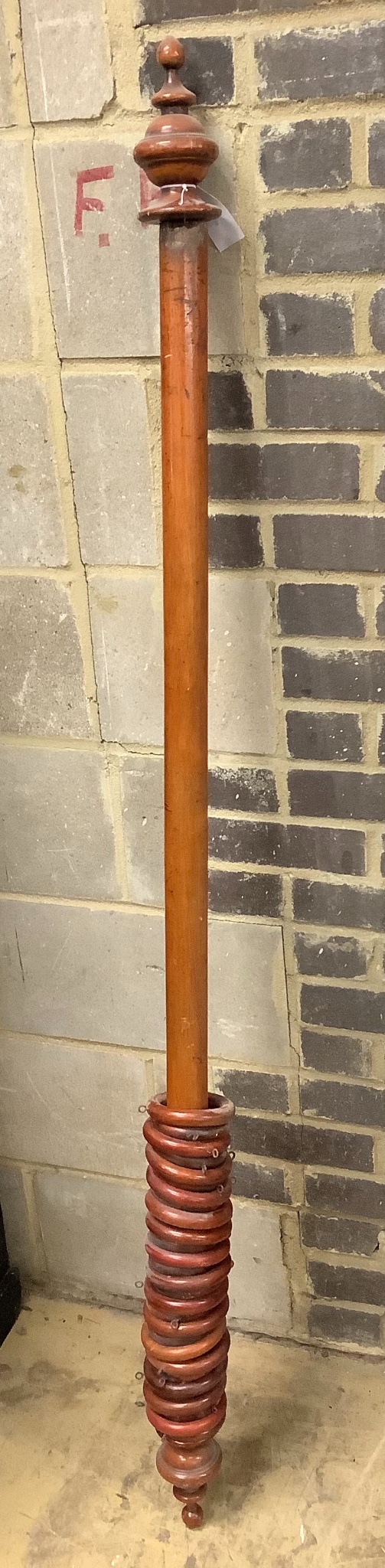 A mahogany curtain pole with rings, length 170cm